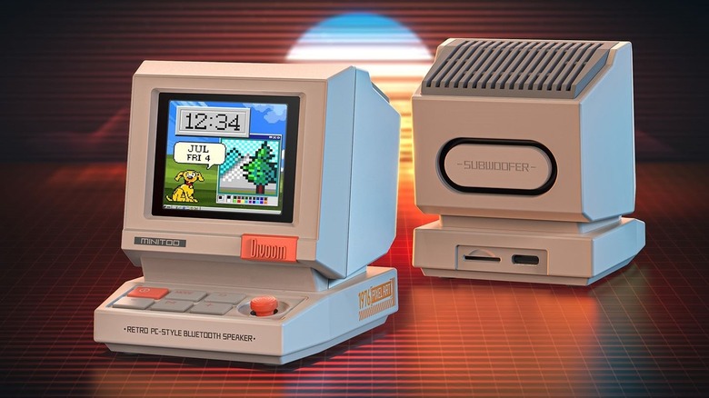 A Divoom MiniToo device displaying pixel art on a desk, styled like a miniature 80s personal computer.