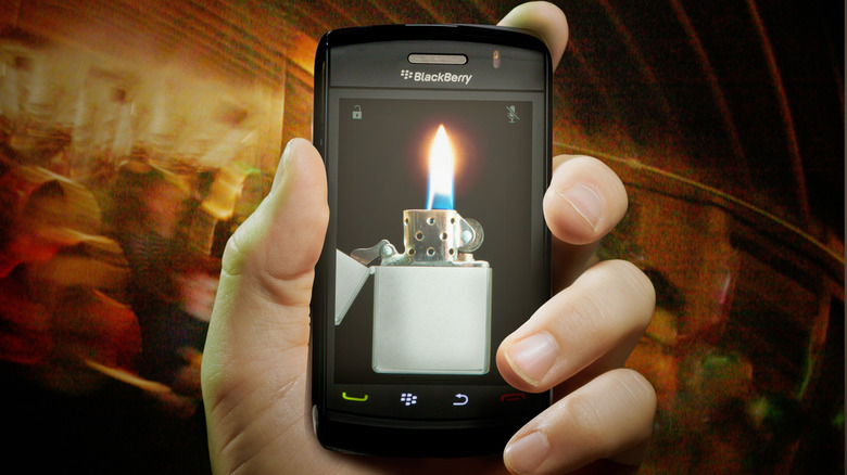 A hand-held BlackBerry Storm phone showing a lighter application on its screen.