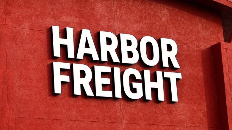 Close-up of the Harbor Freight Tools logo on a bright red store wall.