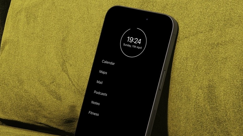 An iPhone running the Minimalist Phone app leaning against a cushion.