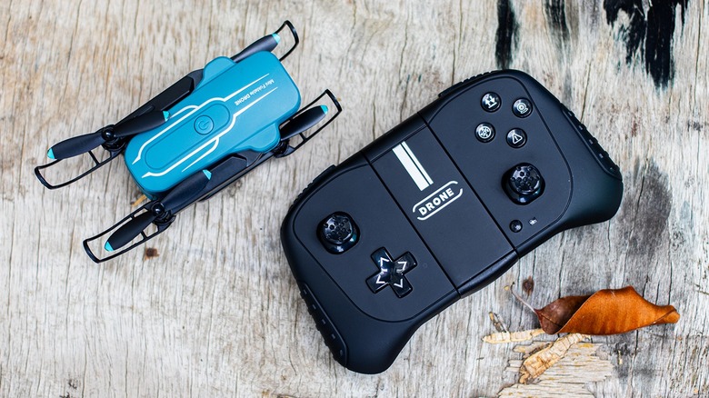 The Oviliee S17 mini drone in its folded configuration next to its dedicated remote controller.