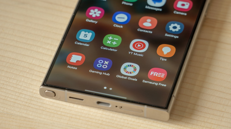 Macro view of the Samsung S24 Ultra screen displaying a clean home screen with various app icons.