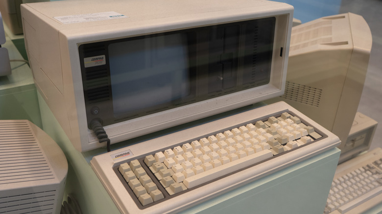 A vintage Compaq computer tower and monitor set up in a typical 90s home office environment.