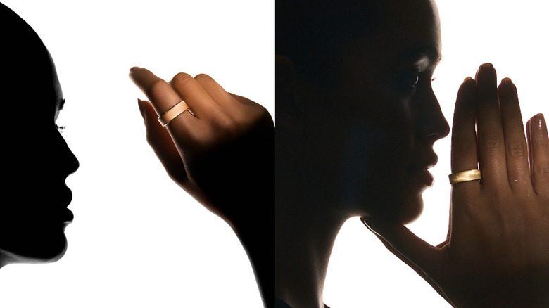 Two hands displaying the different metallic tones of the 18K gold and PT950 platinum Ultrahuman Rare rings.