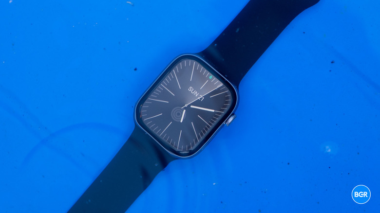 Apple Watch Series 11 submerged in water, showing its water-resistance capabilities.