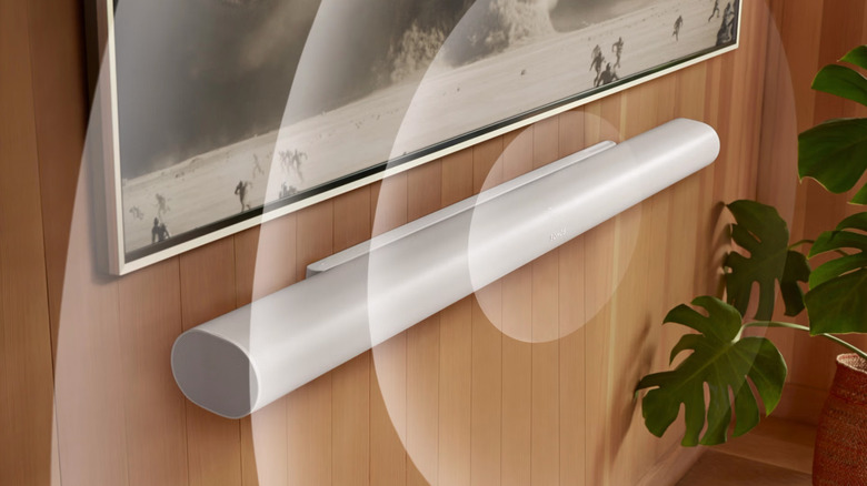 A white Sonos Arc Ultra soundbar mounted on a wall with abstract circles indicating spatial sound projection.