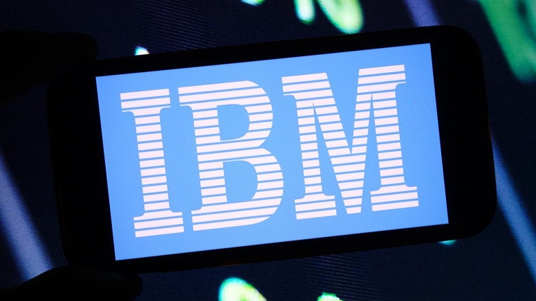 The classic blue IBM logo glowing on the screen of a vintage CRT monitor.