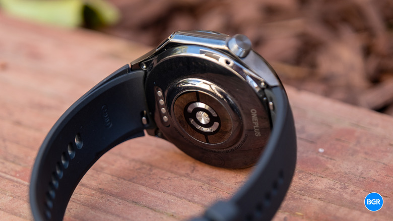 The underside of the OnePlus Watch 3 showing the optical health sensor array.