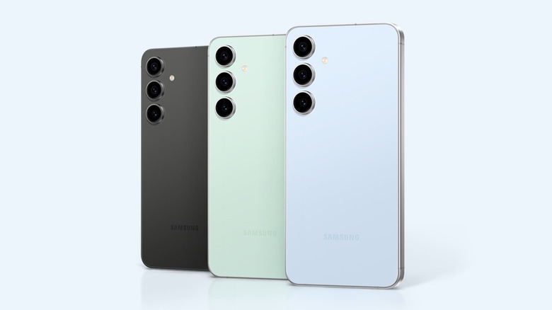 The rear view of three Galaxy smartphones in black, light green, and blue.