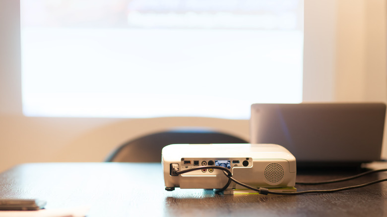 A portable projector connected in an office environment.