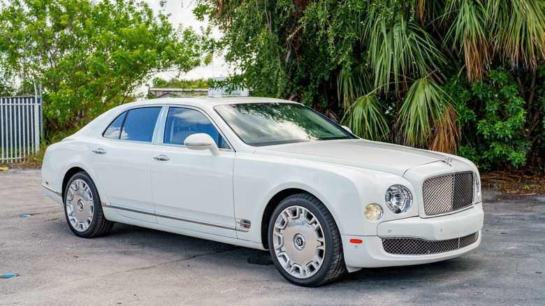 A white Bentley Mulsanne luxury sedan parked in a lot.