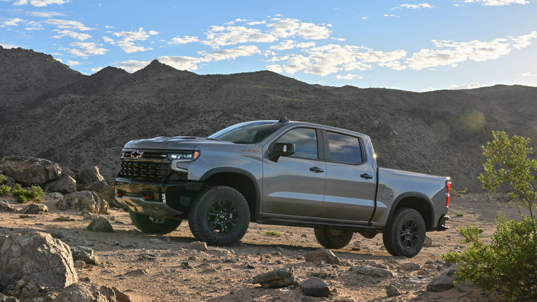 A Chevrolet Silverado ZR2 parked in a scenic mountain landscape during sunset.