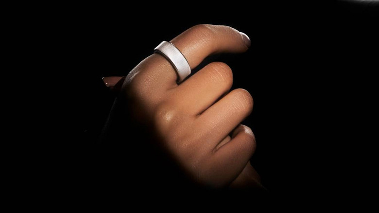 Front view of the platinum Ultrahuman Rare smart ring being worn on a finger.