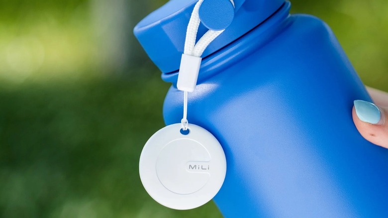 Mili tag tracker attached to a blue water bottle.