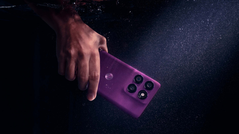 The Motorola Edge 60 Pro submerged in water while being held