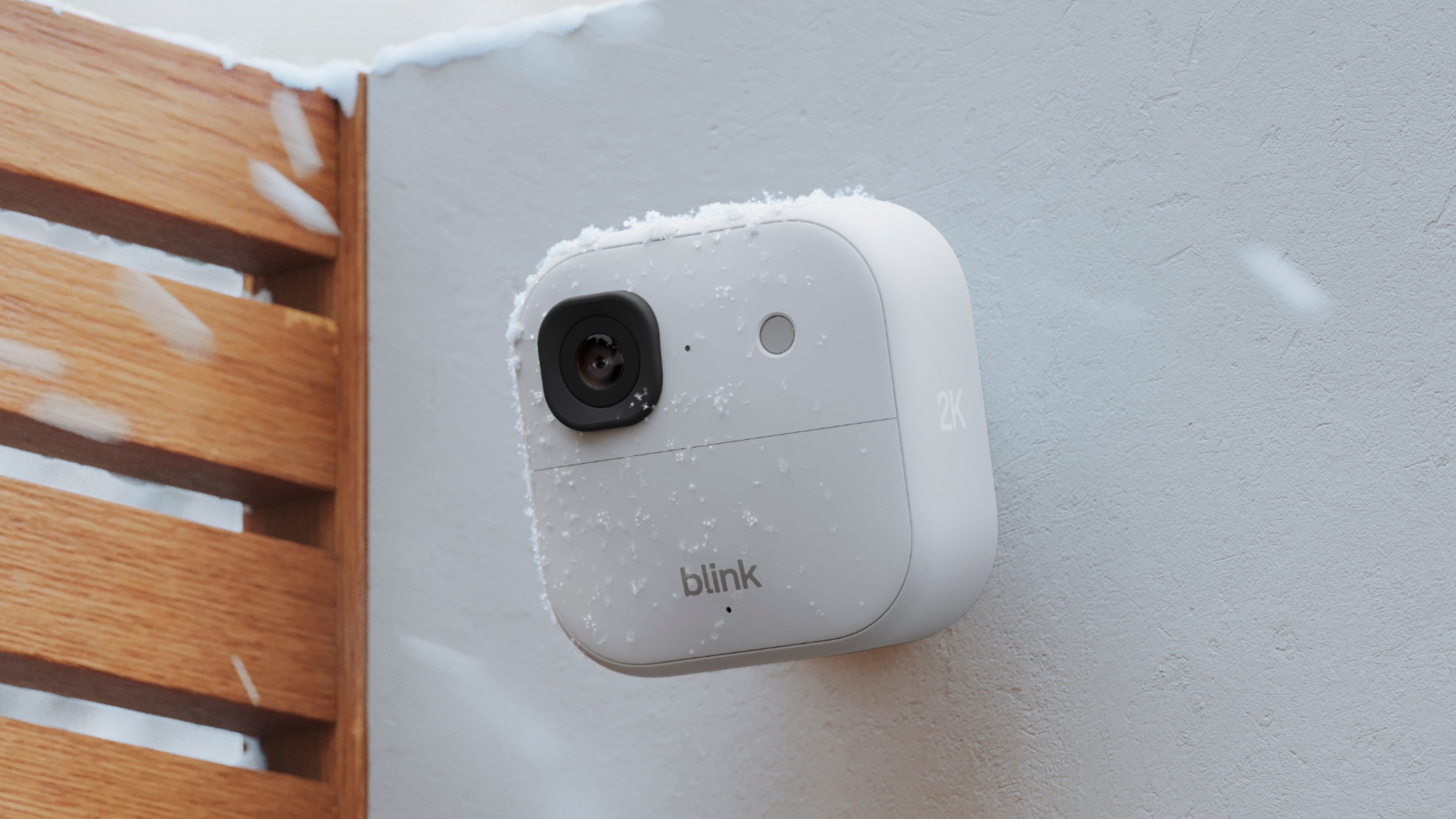 Close-up of the Blink Outdoor 4 camera unit showing the 143-degree lens and infrared sensors.