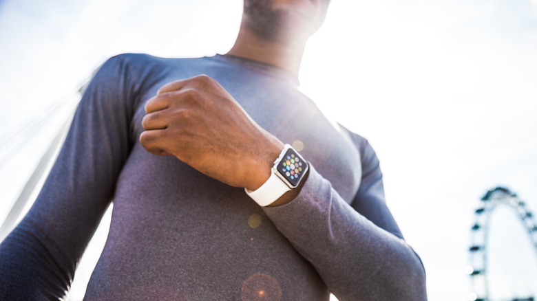 A jogger checking his health stats on his Apple Watch during a workout.