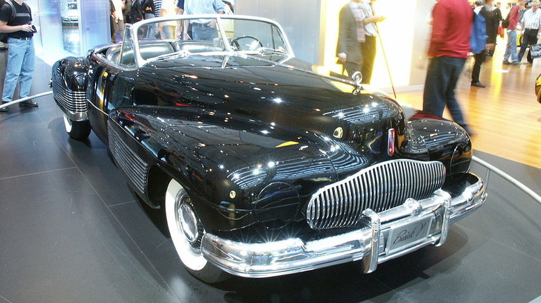 The black 1938 Buick Y-Job concept car with chrome accents and integrated fenders.