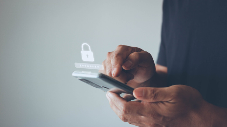 Person using a smartphone with a digital lock icon hovering above the screen to signify enhanced privacy settings.