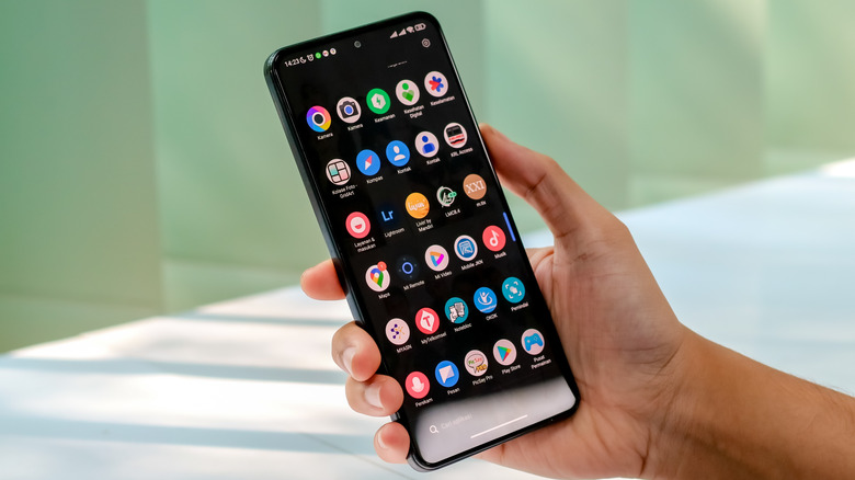 A smartphone showing a customized Android app drawer with various third-party icons.