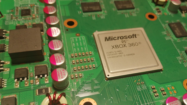 A detailed close-up of the internal circuit board and processor of an Xbox 360.