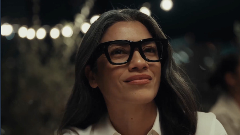 A person wearing the Meta Ray-Ban Display glasses, demonstrating their aesthetic similarity to standard sunglasses.