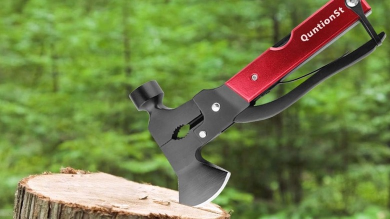 A multi-tool resting on a textured tree trunk in an outdoor environment.