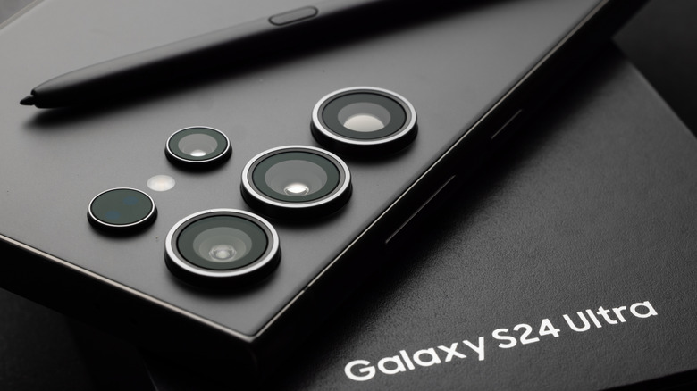 Samsung Galaxy S24 Ultra with S Pen resting on its original retail packaging.