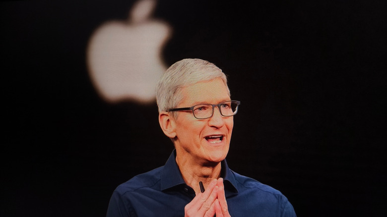 Apple CEO Tim Cook speaking on stage during a keynote event.