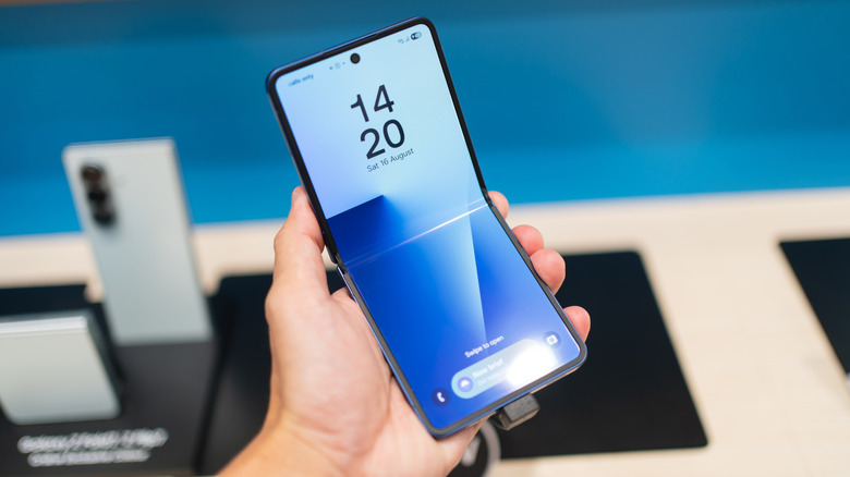 A Samsung Galaxy Z Flip7 held in a retail environment