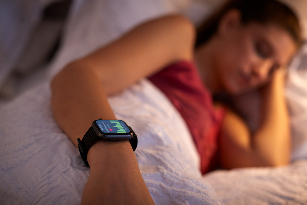 Macro shot of a high-end wearable device showing heart rate variability and sleep cycle graphs.