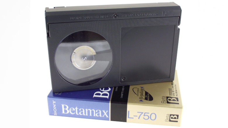 A black Sony Betamax tape resting on its cardboard storage case.