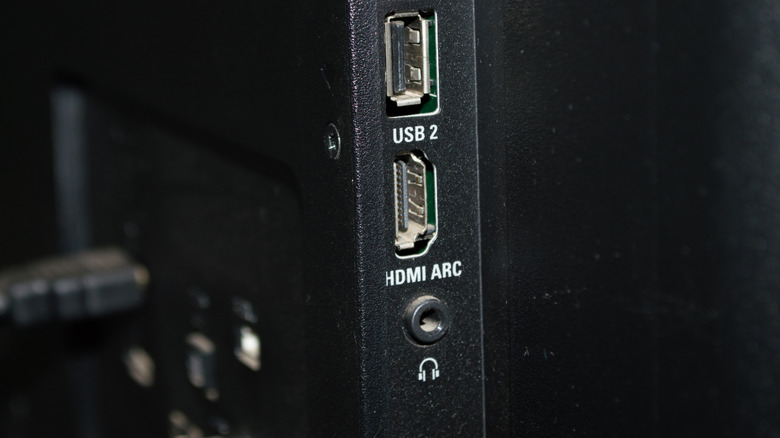 A close-up shot of an HDMI port labeled ARC on the side of a modern television.