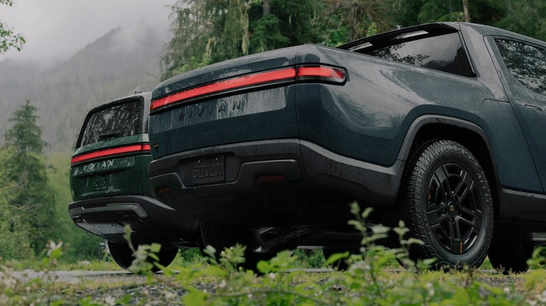 Two Rivian electric vehicles in a natural setting, representing modern native infotainment platforms.