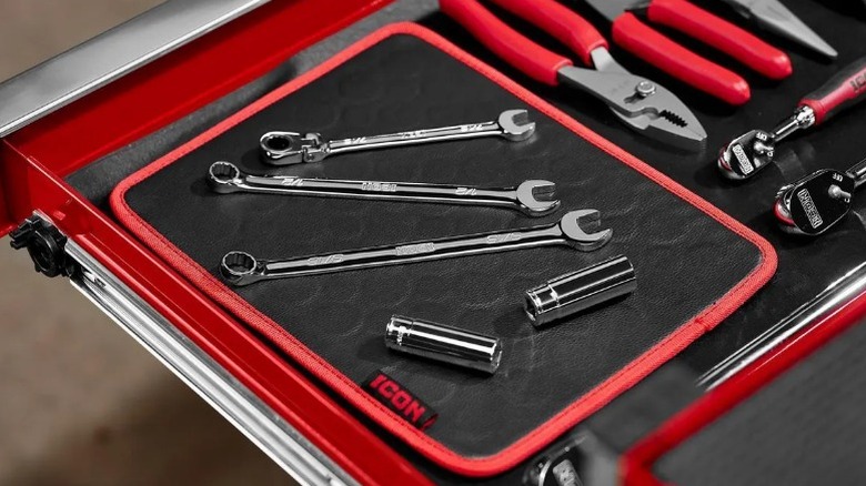 An Icon Magnetic Tool Mat placed inside a tool chest drawer holding various metal parts.