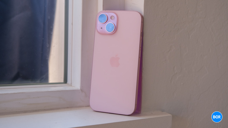 The rear view of the iPhone 15 showing its matte, color-infused glass finish.