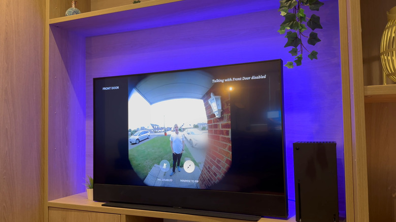 An Amazon Fire TV Stick displaying a live Ring doorbell feed on a television screen.