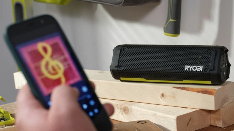 The Ryobi USB Lithium Verse speaker sitting on a workbench providing audio.