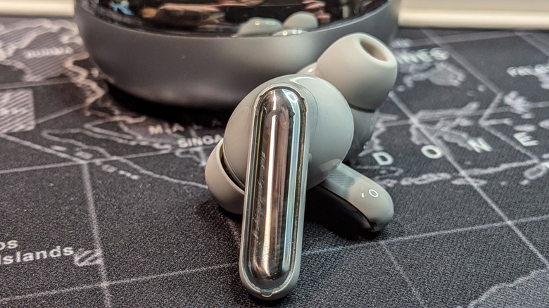 Close-up shot of the Viaim RecDot earbuds resting in their case.