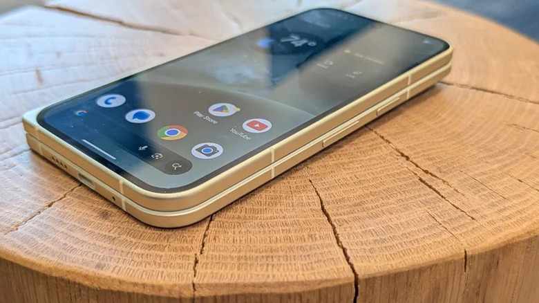 A Google Pixel 10 Pro Fold resting on a wooden table surface.