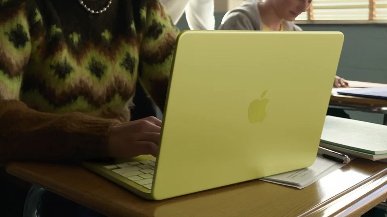 A student using the Apple MacBook Neo in a bright classroom setting.