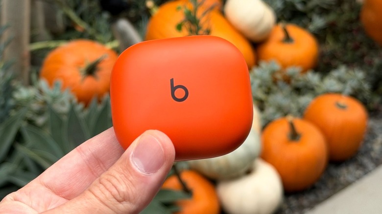 The Powerbeats Fit charging case opened to reveal the storage and charging placement.