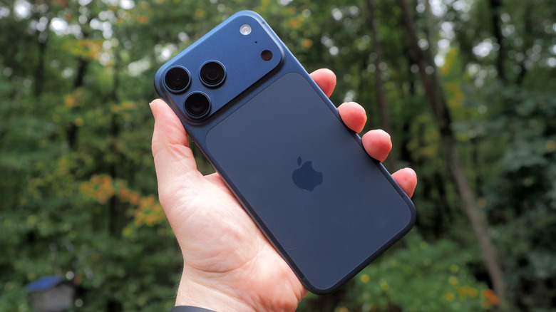 The rear panel of the blue iPhone 17 Pro Max being held in a hand.
