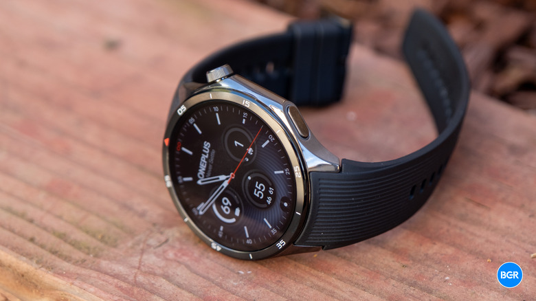 OnePlus Watch 3 sitting on a wooden surface, highlighting its large AMOLED display.
