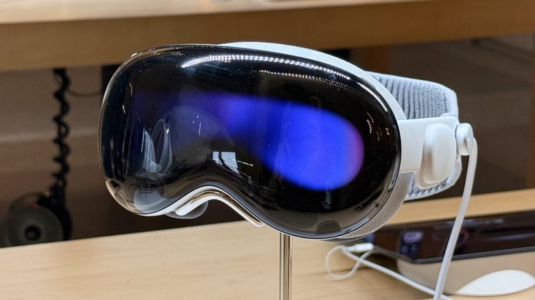 An Apple Vision Pro headset on display in a brightly lit Apple Store.