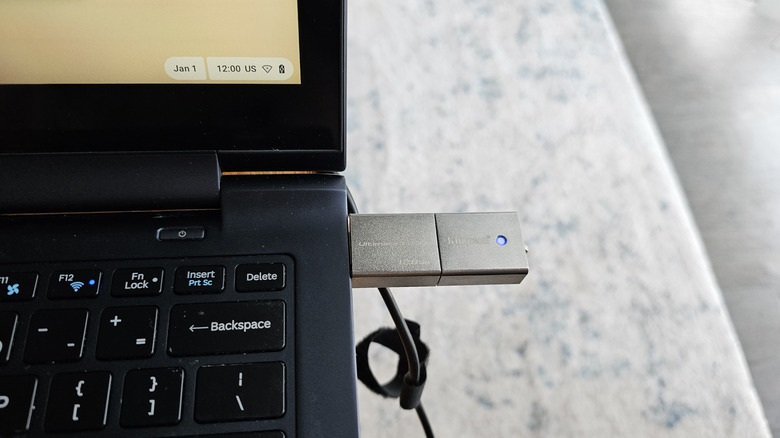 A Kingston USB flash drive plugged into the side port of a Chromebook.
