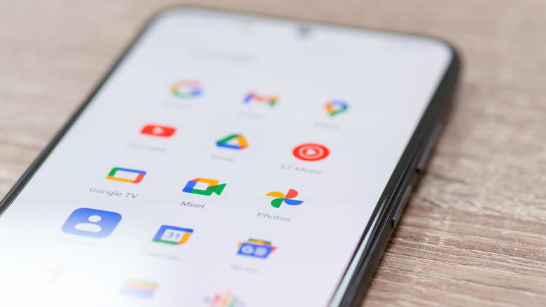 An Android smartphone showing a variety of Google and third-party app icons.
