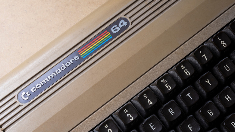 A macro close-up of the Commodore 64 logo on the computer's top casing.