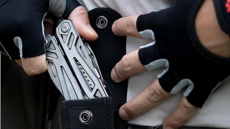 WETOLS multi-tool placed inside its durable black nylon carrying case.