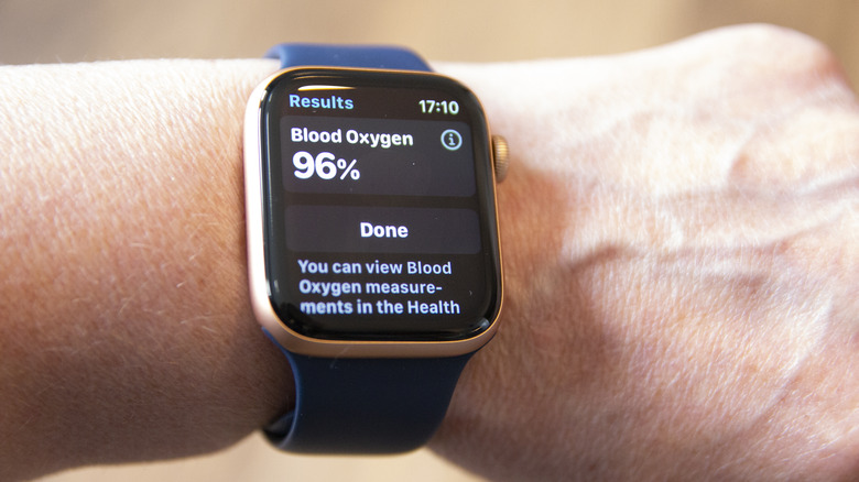 A close-up view of an Apple Watch display showing a blood oxygen level percentage.